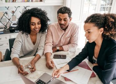 An accountant explaining insurance options to a couple.