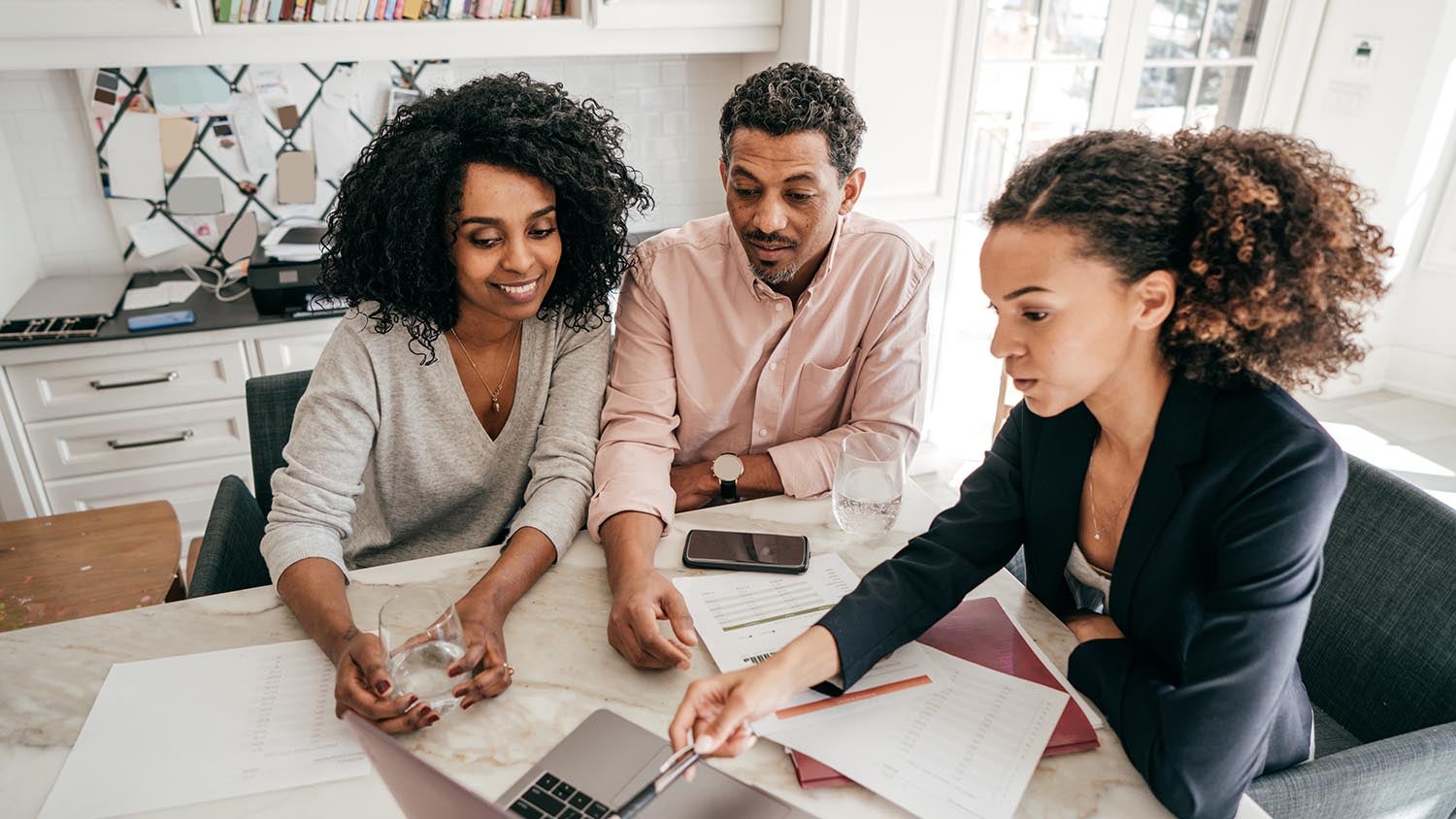 An accountant explaining insurance options to a couple.