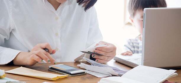 woman updating her kakeibo